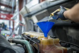 Mobile oil change being performed on a diesel engine