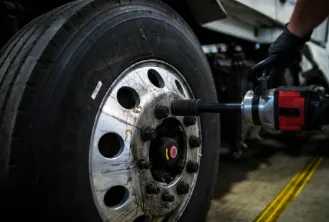 Mobile tire service on a truck wheel with an impact wrench
